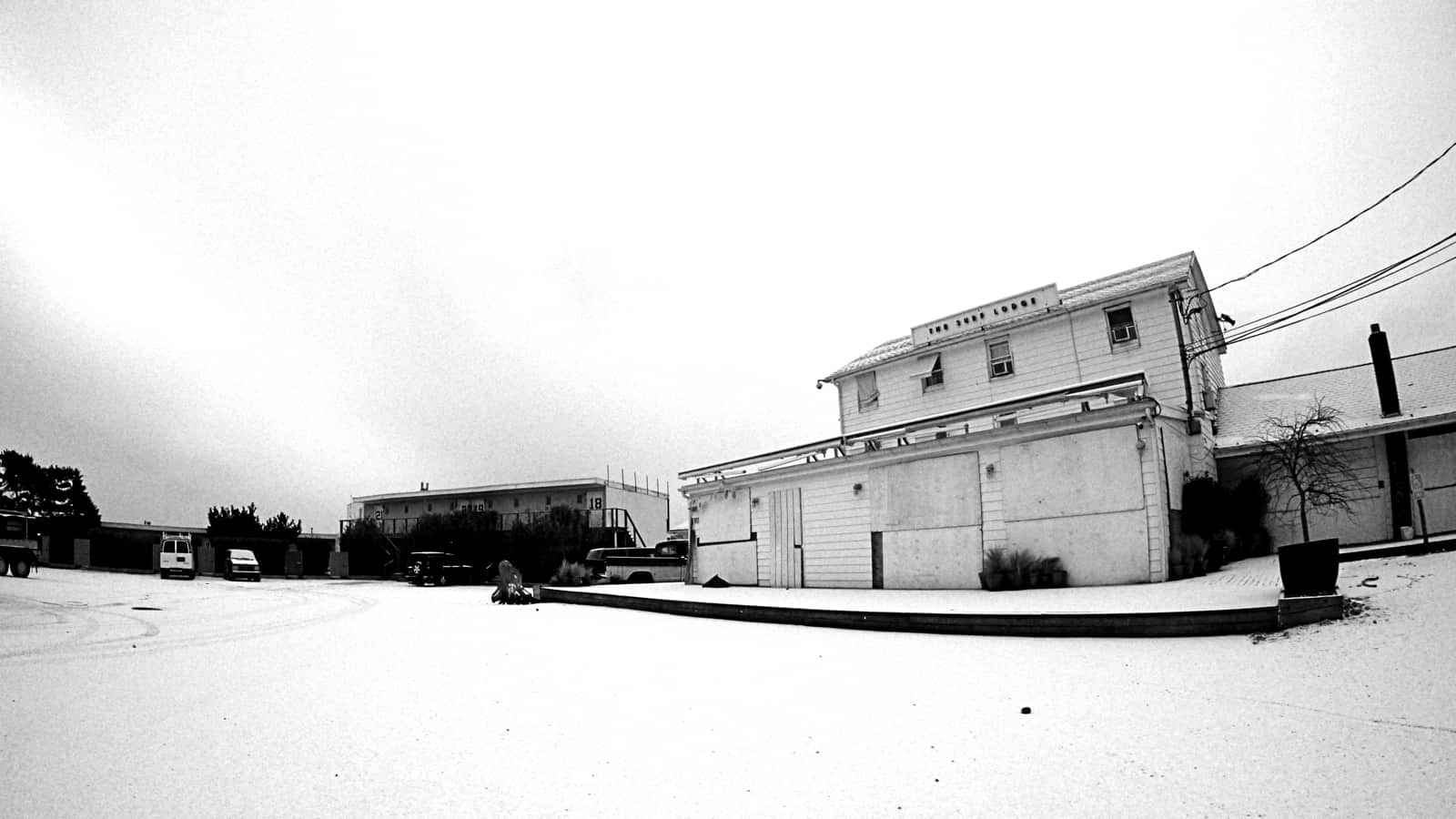 White snow covers white sand in the Surf Lodge parking lot, Montauk NY, photo by Sailing Montauk