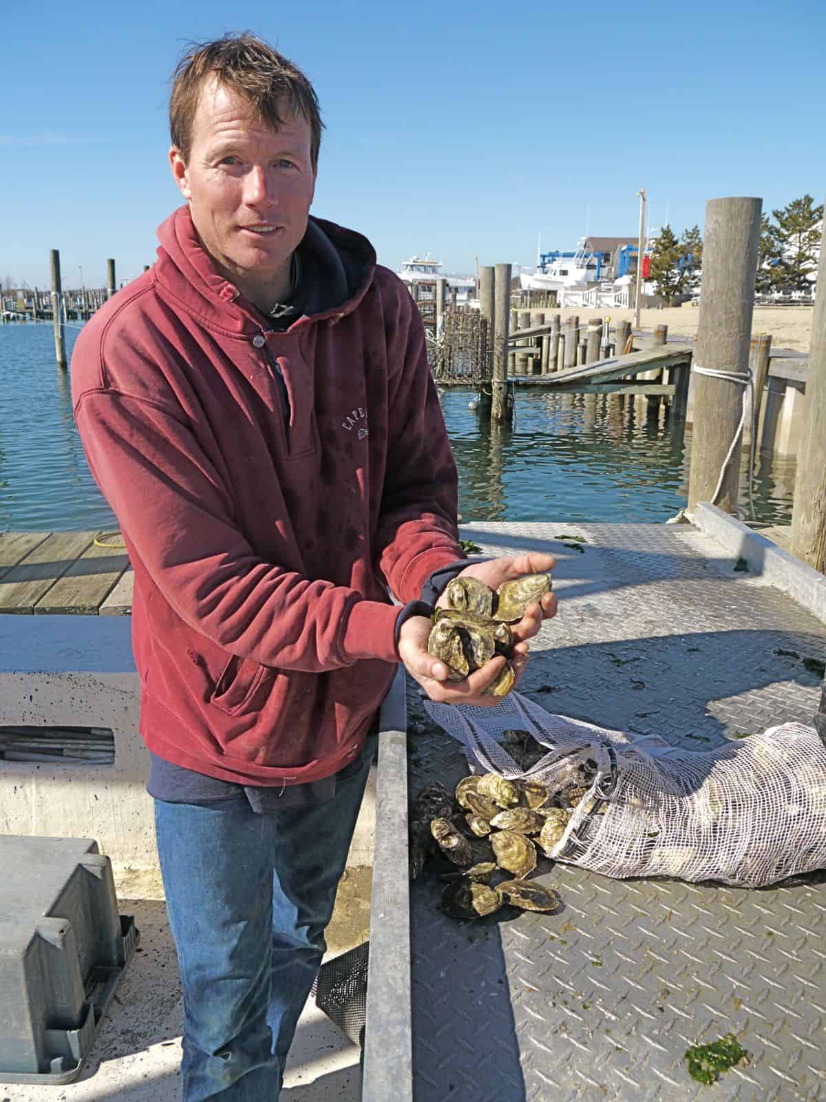 Mike Martinsen of the Montauk Shellfish Company counting out a dozen "Montauk Pearls" oysters, photo by Sailing Montauk